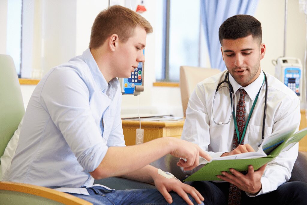 Two men discussing a document in a professional setting.