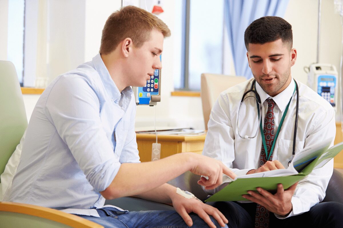 Two men discussing a document in a professional setting.